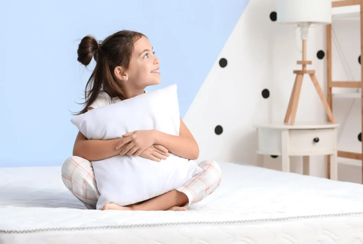girl sitting with pillow