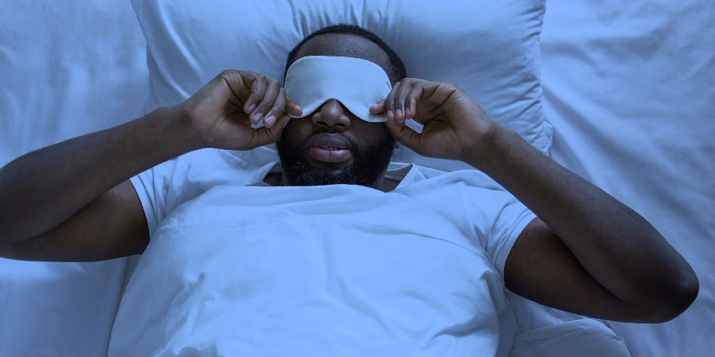 man-putting-on-sleep-mask
