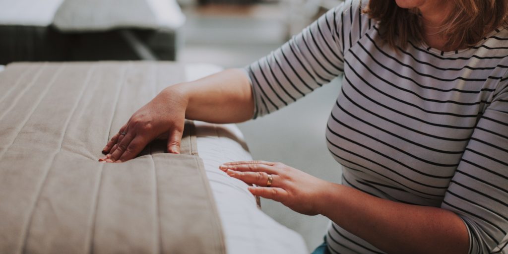 Woman touching mattress