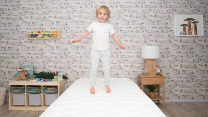 kid jumping on mattress