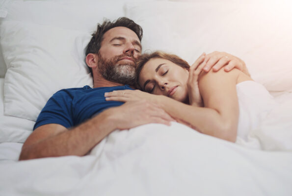 Relax, cuddle and couple with sleeping in bed for marriage, commitment or comfort in rest at home. Partner, love and man with embrace of woman in house for dreaming, tired or afternoon nap on weekend Relax, cuddle and couple with sleeping in bed for marriage, commitment or comfort in rest at home. Partner, love and man with embrace of woman in house for dreaming, tired or afternoon nap on weekend